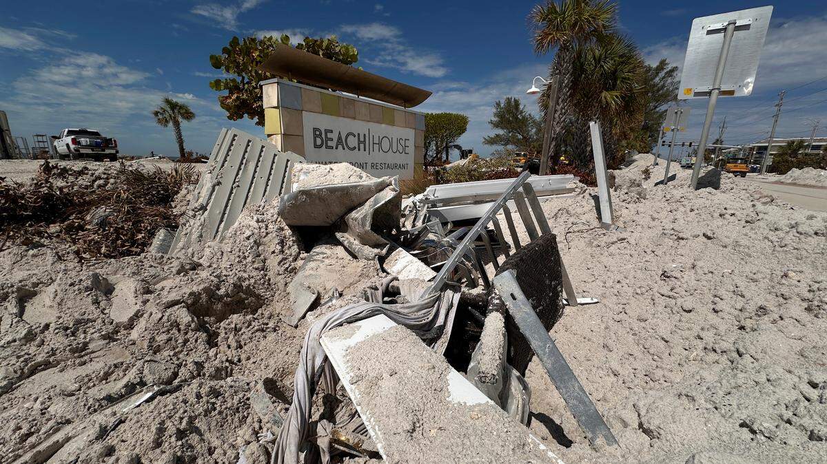 Debris piled up in front of the Beach House’s sign on Gulf Drive in Bradenton Beach after Hurricane Helene on Oct. 2, 2024.