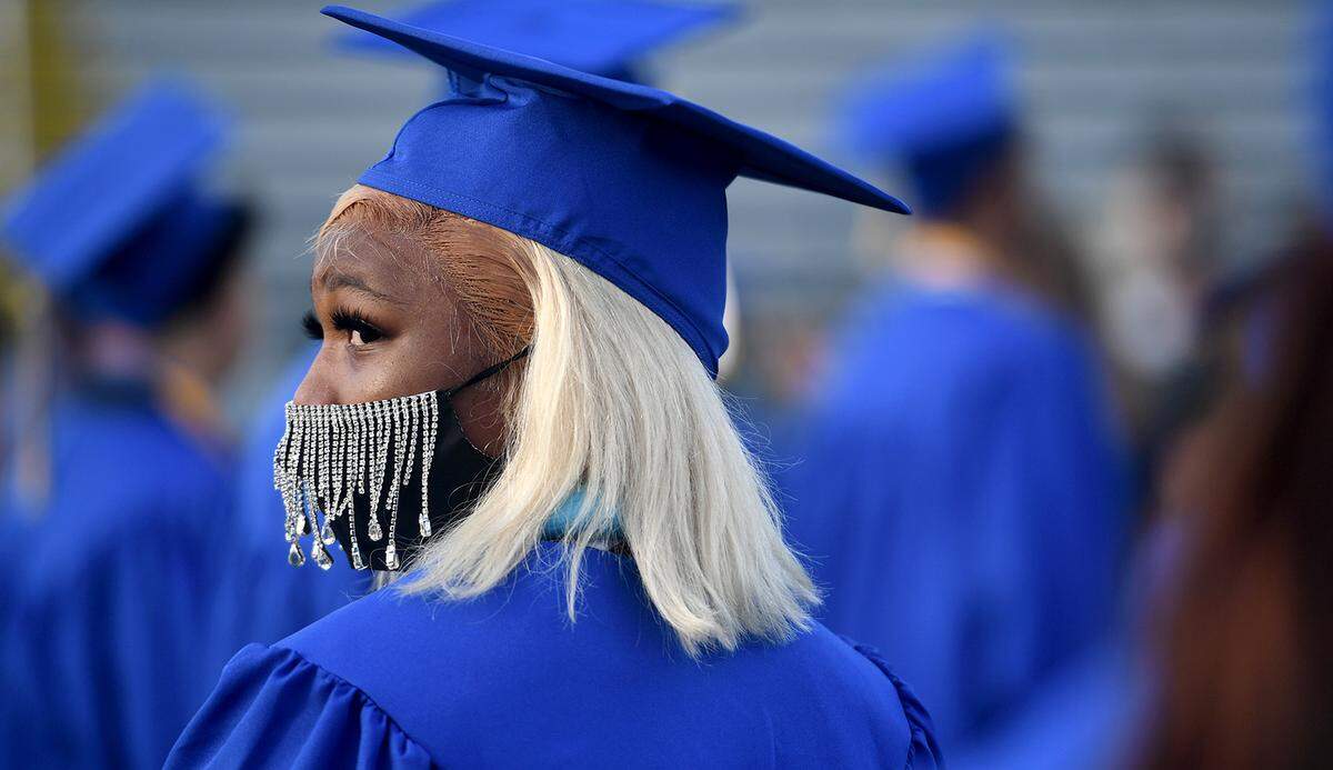 06/03/21—Myniea Handy wears a jeweled mask at Bayshore High School’s commencement ceremony at LECOM Field.