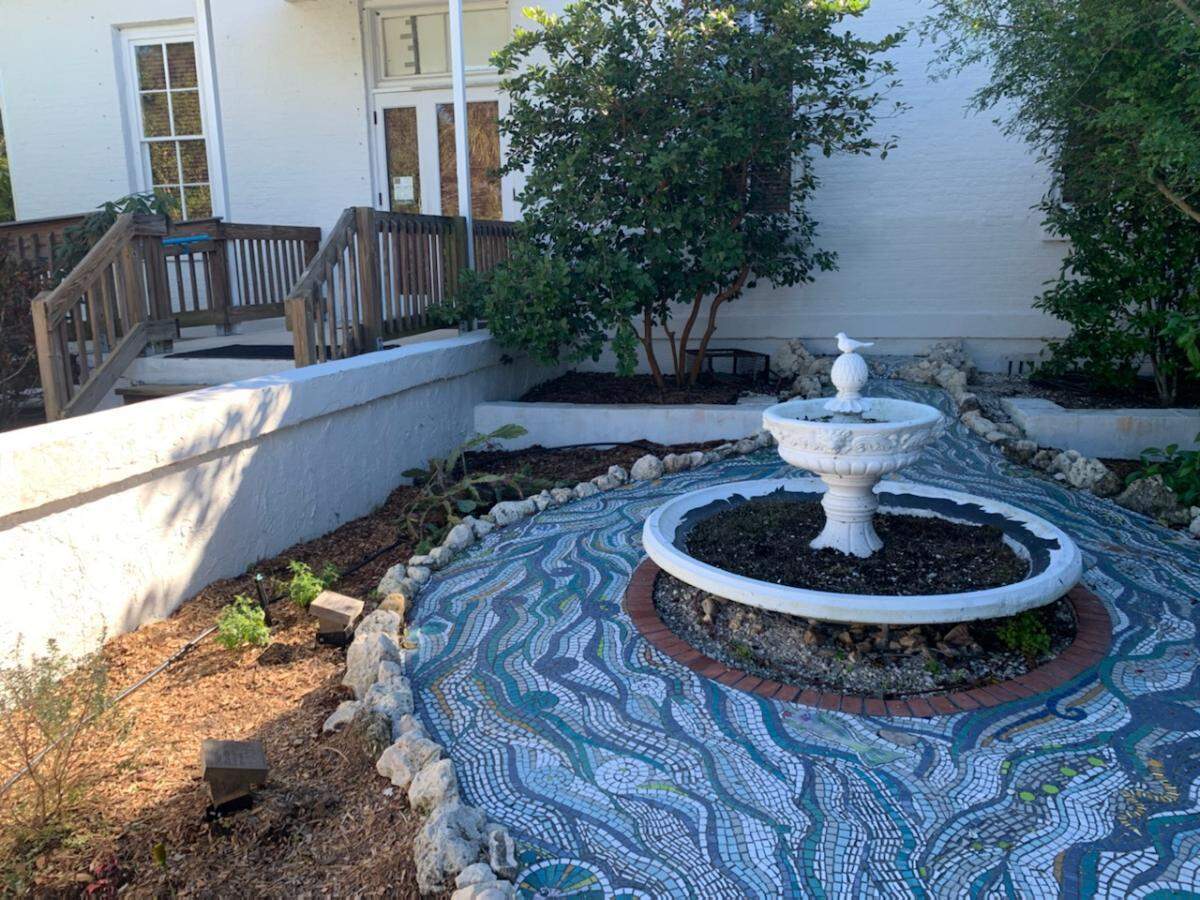 A new river mosaic in the Florida Maritime Museum’s butterfly garden is made up of individual waves created by volunteers and then assembled by mosaic artist Pearse Kelly.