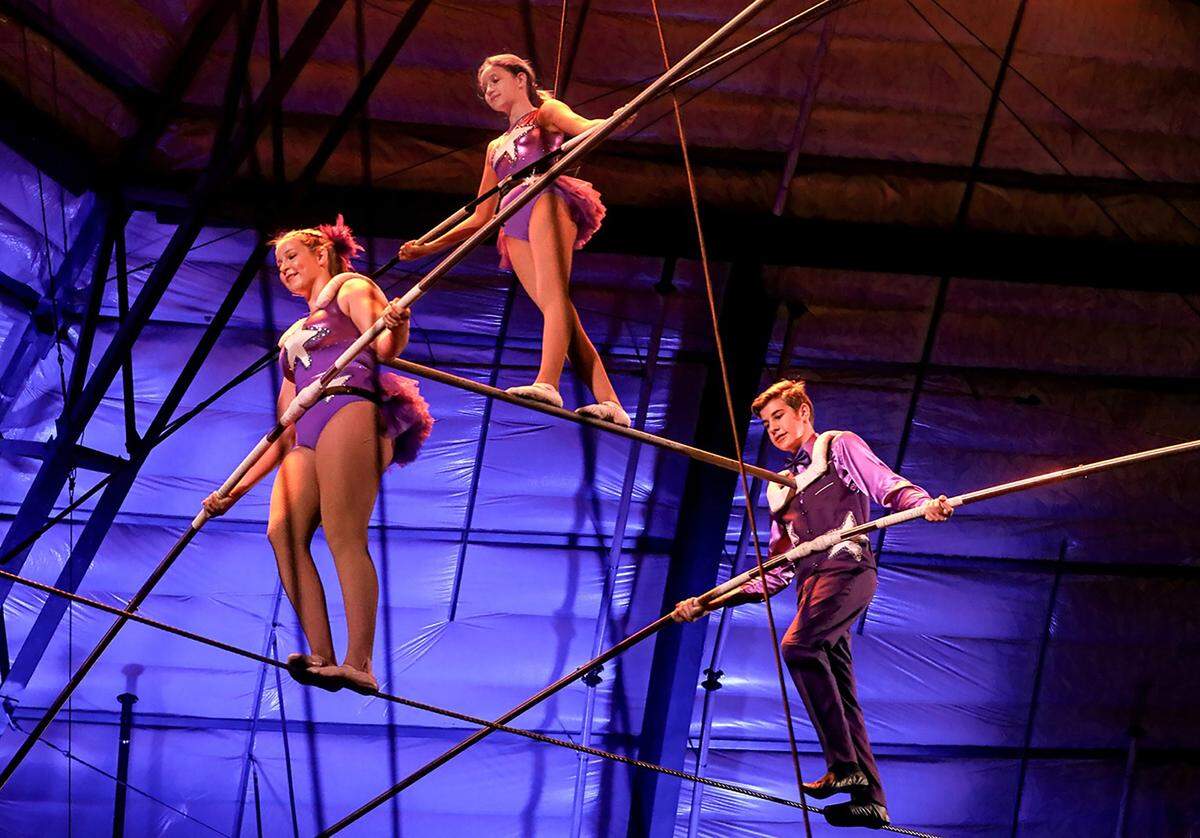 Sailor Circus students Iliana Tice, Iris Dahlborg and Caleb Overholt defy gravity on the high wire