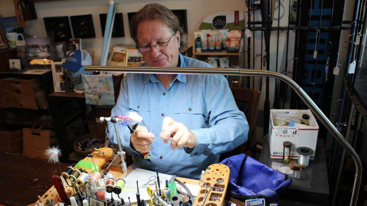 Steve Traves makes a saltwater fly at AMI Outfitters Coastal Gear and Apparel, 401 Pine Ave., Anna Maria.