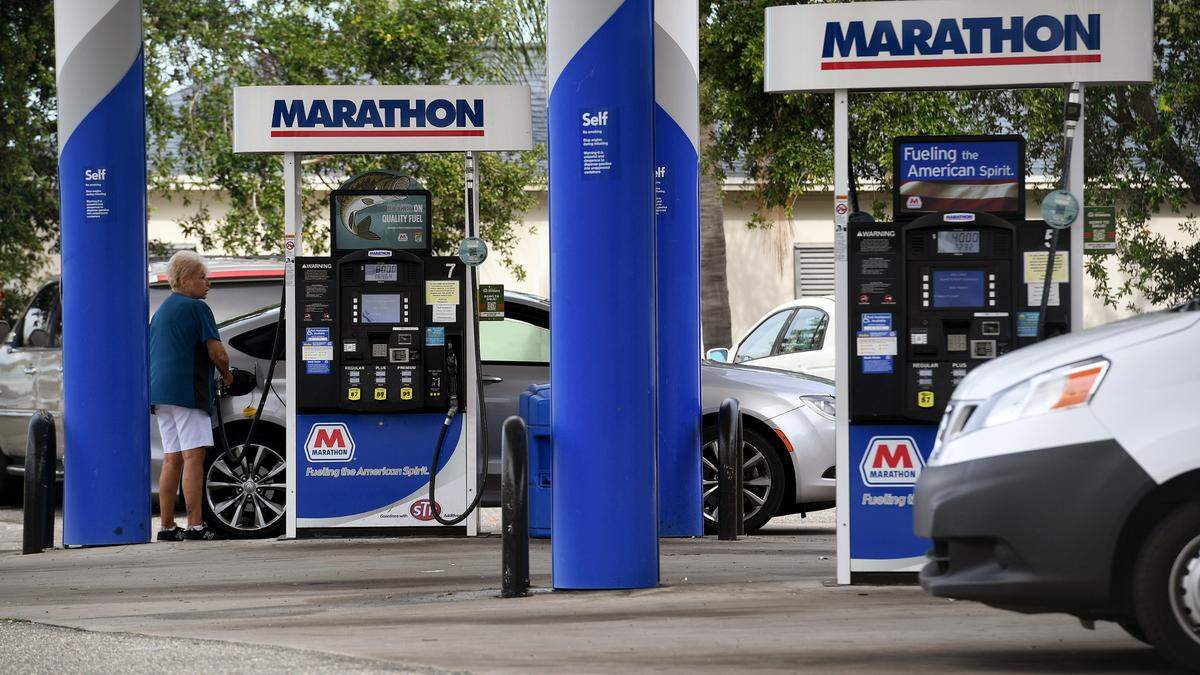 A motorist gasses up at a station in Bradenton. Rain bands from a tropical disturbance impacting South Florida had not made their way to Manatee County beaches mid-morning Friday. The National Hurricane Center is forecasting the system to slightly strengthen into a tropical storm.