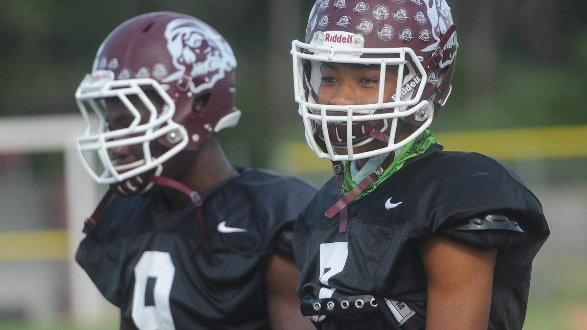 Jojo Louis and Demetrius Lawson take part in drills Wednesday as his team prepares to face Thomas Aquinas High in a Class 7A state semi final game Friday at Braden River High. 
 GRANT JEFFERIES/Bradenton Herald