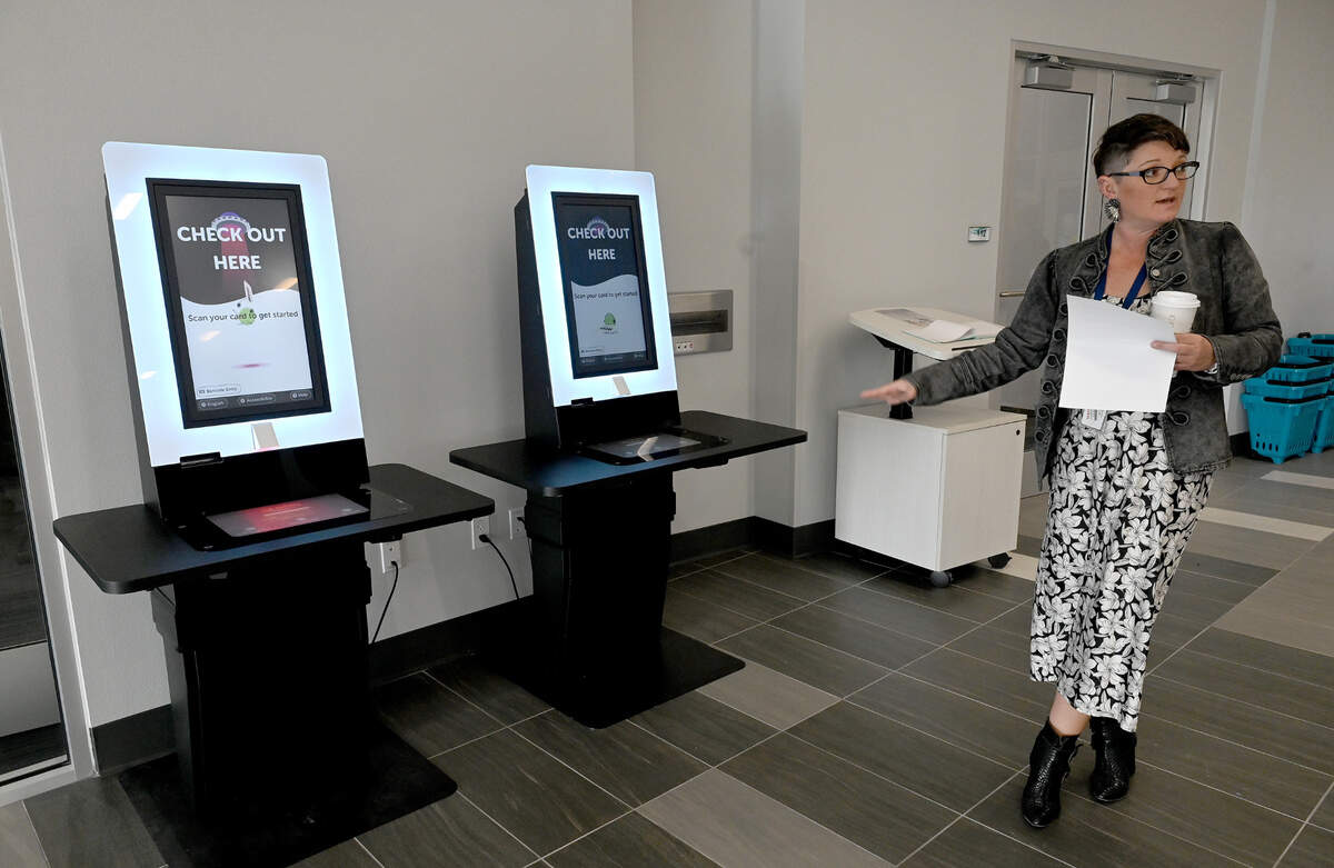 Branch Supervisor Tiffany Mautino points out a check-out kiosk at the county’s newest library. The Lakewood Ranch Library at 16410 Rangeland Parkway will open Friday, Jan. 12, 2024.