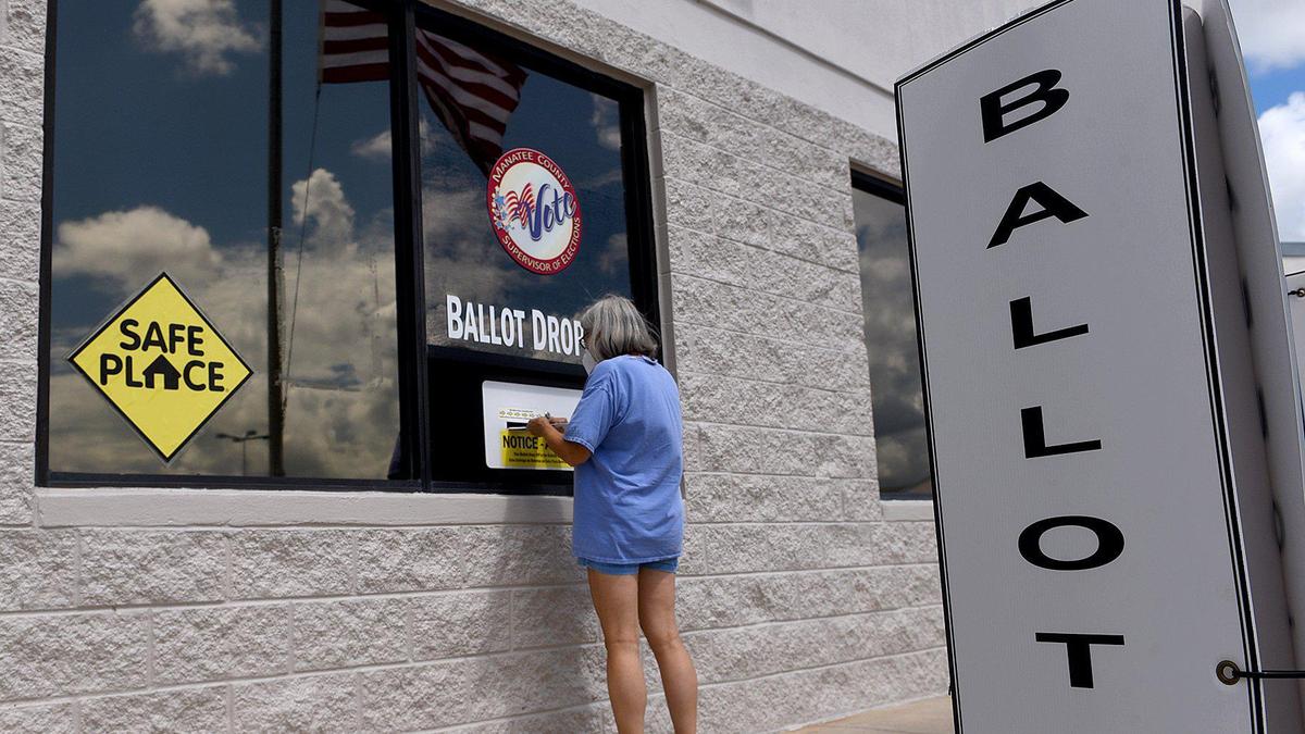 A woman drops off her ballot for the general election at Manatee County Supervisor of Elections office in this Bradenton Herald file photo.