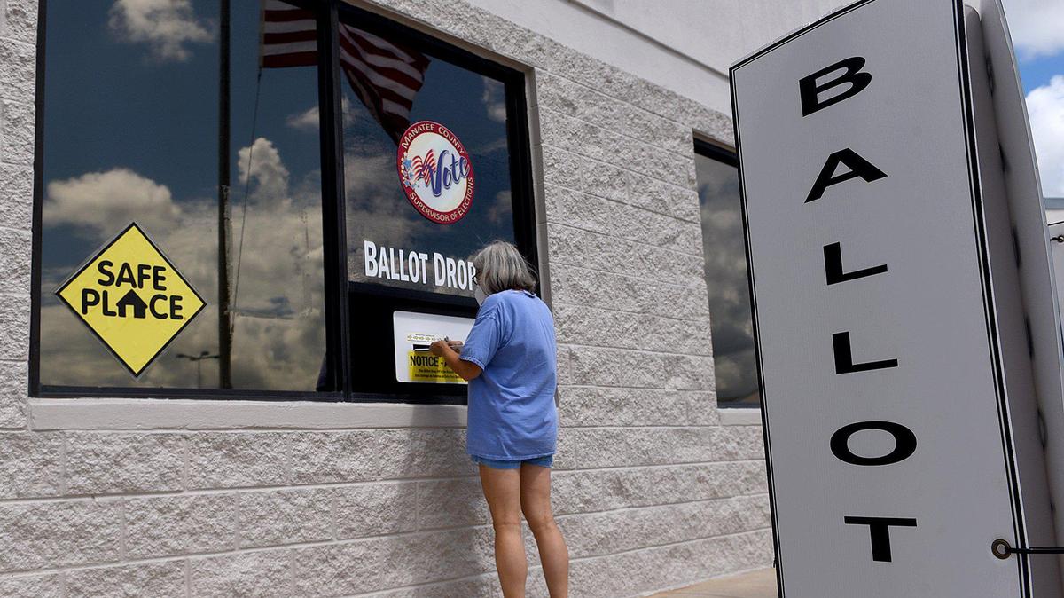 A woman drops off her ballot for the general election at Manatee County Supervisor of Elections office in Bradenton in this Bradenton Herald file photo.