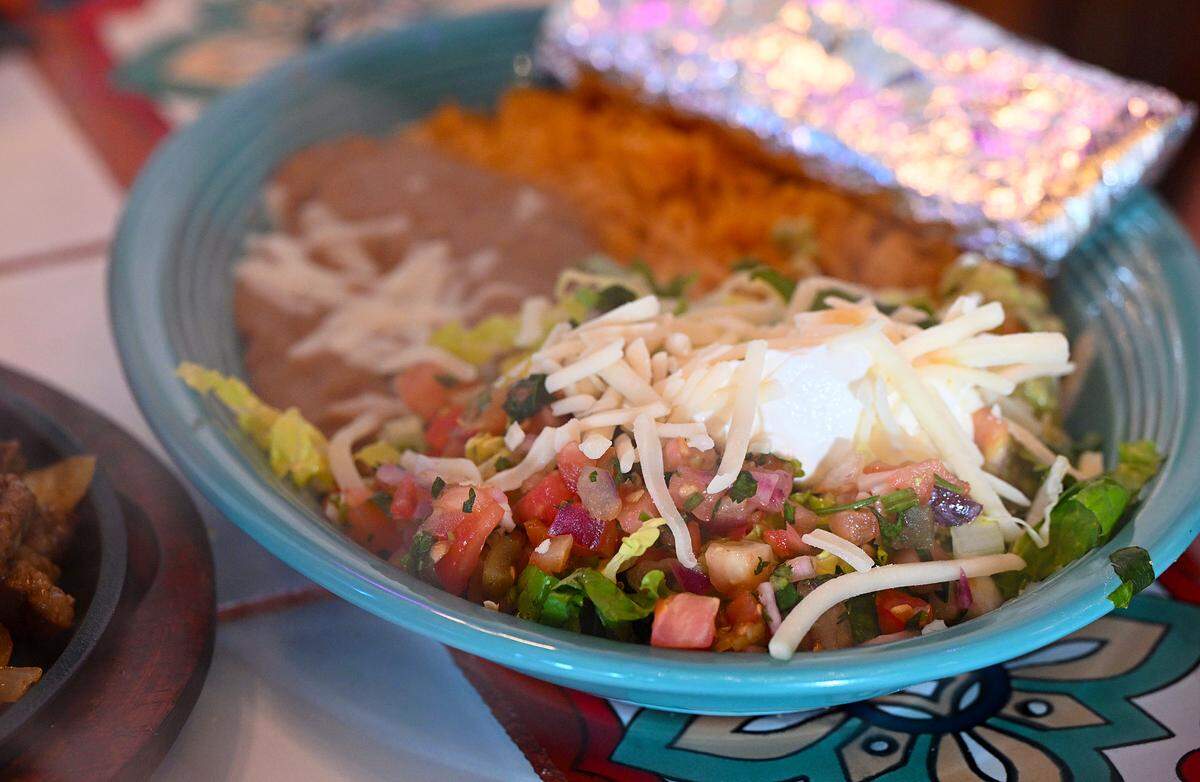 Part of the fajita platter for two includes separate plates with beans, cheese, sour cream and more at Aqua Tequila Mexican Restaurant Grill and Cantina in Parrish on Feb. 19, 2026.