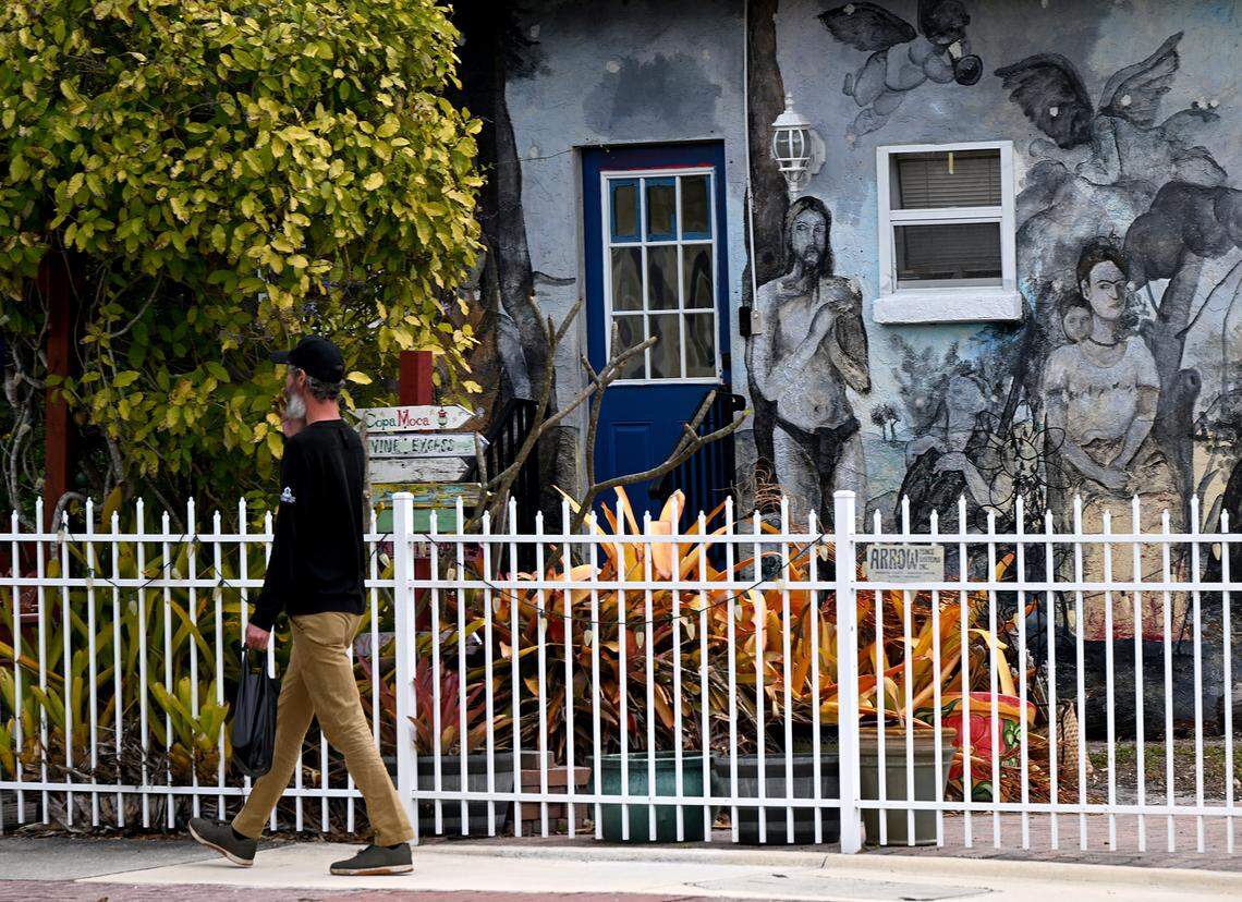 The Village of the Arts in Bradenton is holding a WonderWall Mural Fest to celebrate arts and connect with the community on March 7, 2026. A pedestrian walks past a home with a mural on Feb. 26, 2026.