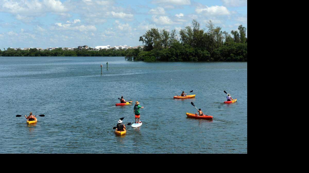 Paddlers travel along the shores of Anna Maria Sound with the shoreline of the proposed Harbor Sound development in the background in this 2014 file photograph. Pat Neal is planning to develop a 40-acre parcel just beyond the mangrove tree line for his personal use and that of his family.
