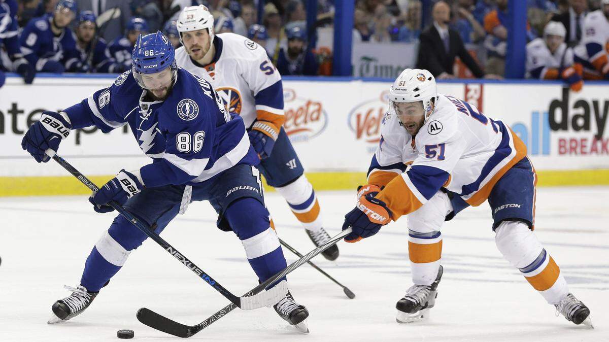 Tampa Bay Lightning's Nikita Kucherov (86), of Russia, and New York Islanders center Frans Nielsen (51), of Denmark, fight for control of the puck during the second period of Game 5 of the NHL hockey Stanley Cup Eastern Conference semifinals Sunday, May 8, 2016, in Tampa, Fla. (AP Photo/Chris O'Meara)