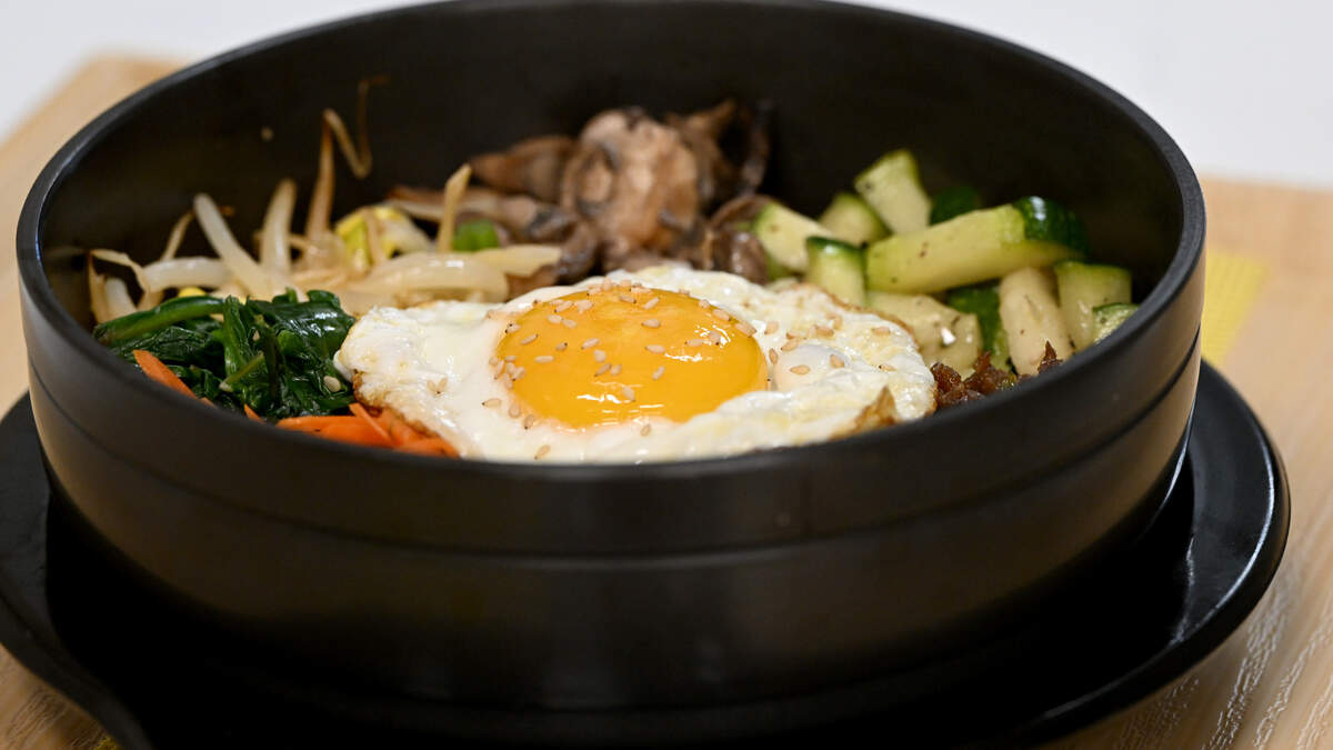 A hot stone Bibimbap with carrots, zucchini, spinach, pickled cucumbers, mushrooms, bean sprouts and fried egg. Sisters Mary Pierson and Katherine Kim have opened a traditional Korean restaurant with some modern touches at Sunny Seoul Korean Kitchen, 9750 State Road 64, shown here on March 18, 2026.