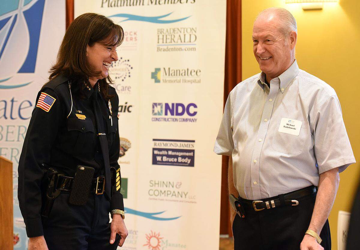 Newly appointed Bradenton Police Chief Melanie Bevan shares a laugh with former chief Michael Radzilowski at a VIP luncheon honoring both chiefs hosted by the Manatee Chamber of Commerce.