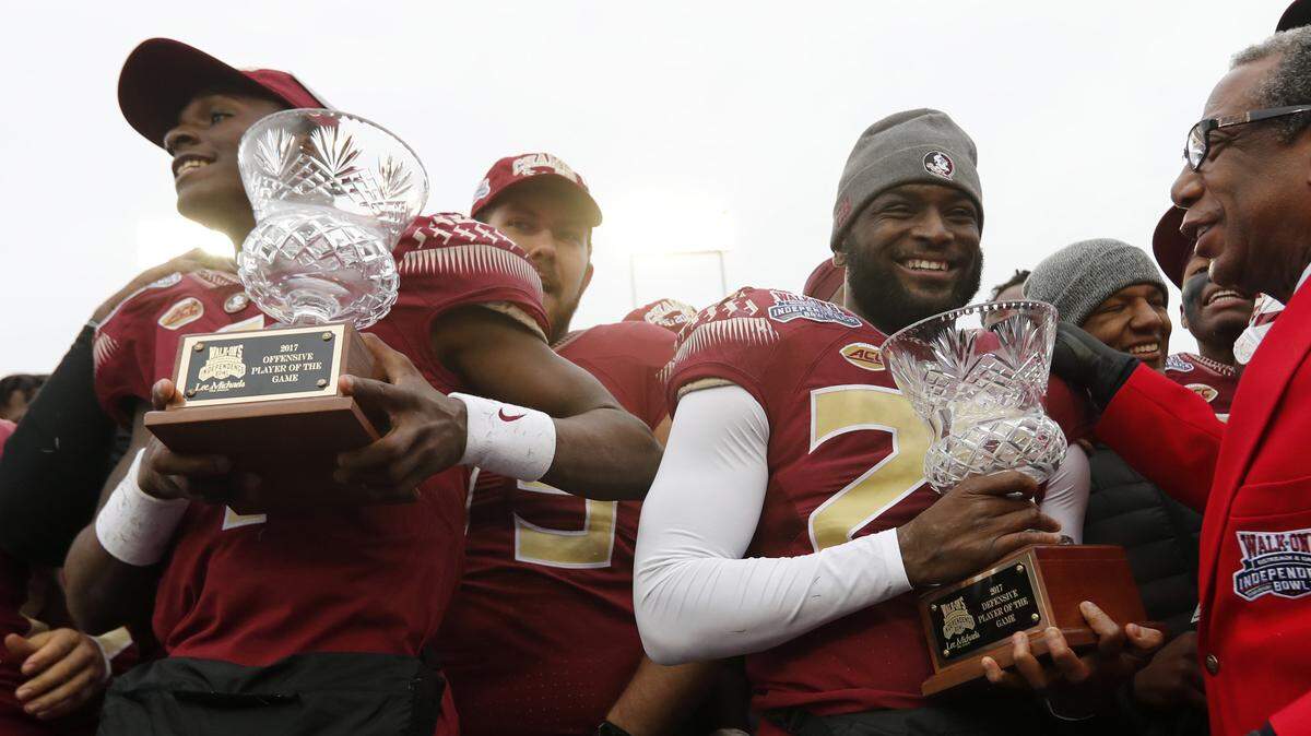 In this file photo, Florida State quarterback James Blackman, left, and defensive back Nate Andrews, hold their offensive and defensive players of the game trophy after defeating Southern Mississippi in the Independence Bowl NCAA college football game in Shreveport, La., Wednesday, Dec. 27, 2017.