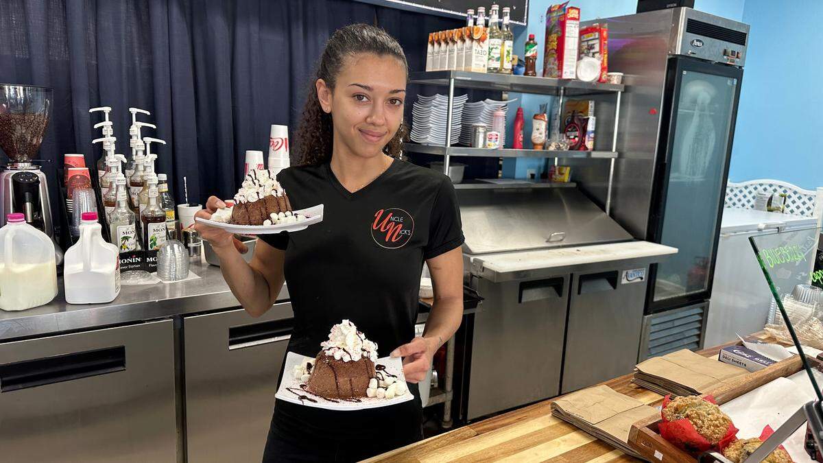 Peaches Harris serves up a pair of chocolate Vampire Penguins with peppermint drizzle, marshmallows and whipped cream at Uncle Nick’s N.Y. Style Bagels, Subs & Deli, 5917 Manatee Ave. W., Bradenton.