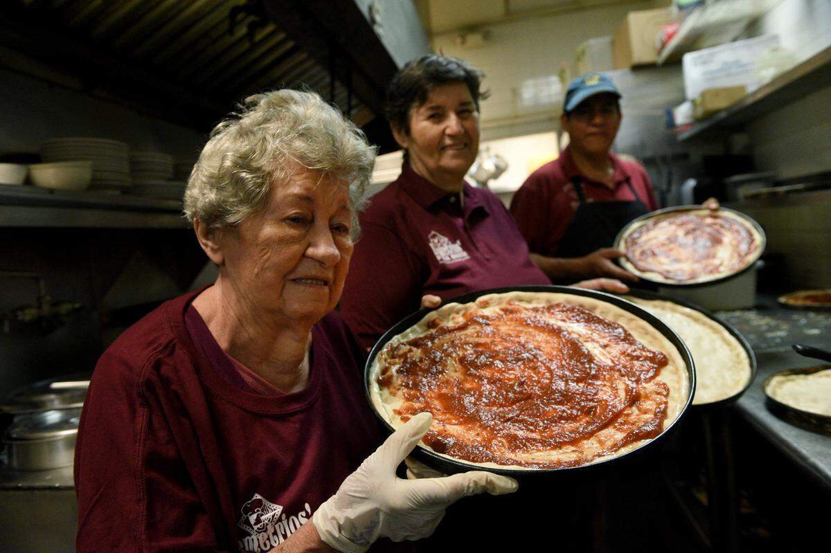 Bradenton’s icon of family dining and pizza, Demetrios, will be closing their doors on April 16. They are so grateful to the community who has loved them all the years they have been open, they say, but they want to have time for their family. Helen Sokos, Paula Ludera. and Herman German make pizzas.