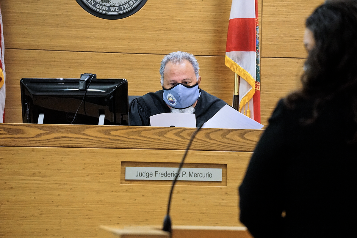 9/30/21 -- Circuit Judge Frederick Mercurio reviews the documents in Benjamin Moulton’s case during a first appearance hearing on Thursday afternoon.