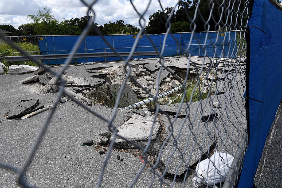 The sinkholes in Cortez Plaza continue to grow as businesses carry on as usual around fenced off areas.