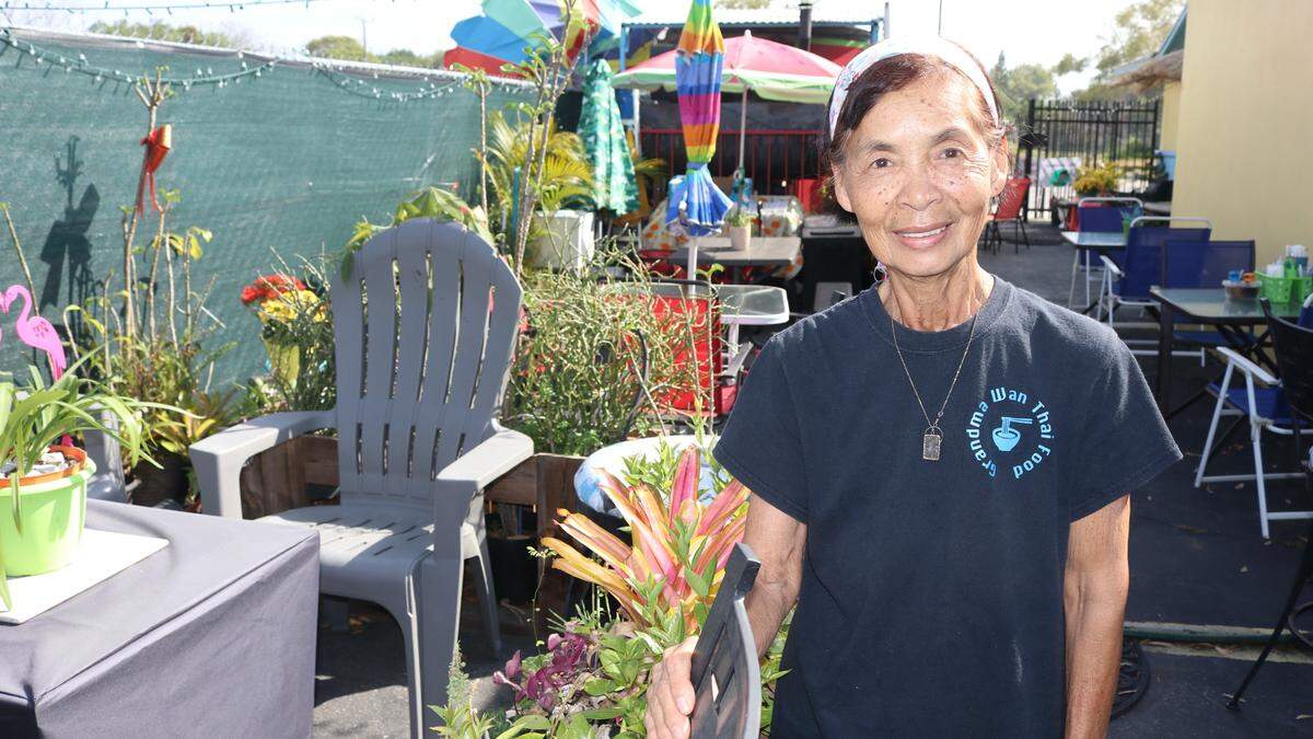 Grandma Wan stands March 9, 2022, in her outdoor garden dining area, where some of the herbs and seasonings use in her cooking are grown.