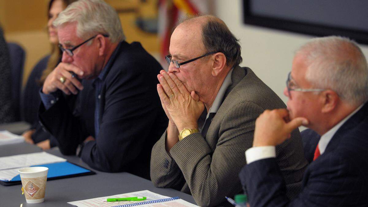 State College of Florida Board members Rick Hager, Craig Triqueiroa and Carlos Beruff listen to public comments before voting on a final draft to end tenure policies at the college despite objections from the school's faculty. 
 GRANT JEFFERIES/Bradenton Herald