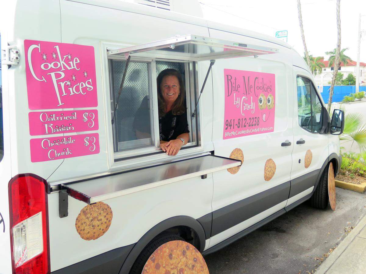 Cindy Unzicker, owner of Bite Me Cookies by Cindy, poses for a photo through the service window of her van in this 2018 file photo.