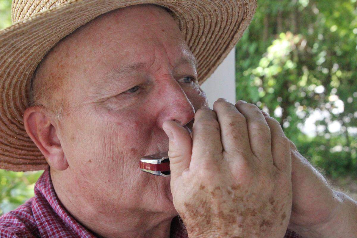 Erwin Wunderlich plays a Civil War-era tune on harmonica. He will share his knowledge with children at a pair of workshops on July 14 at Manatee Village Historical Park.