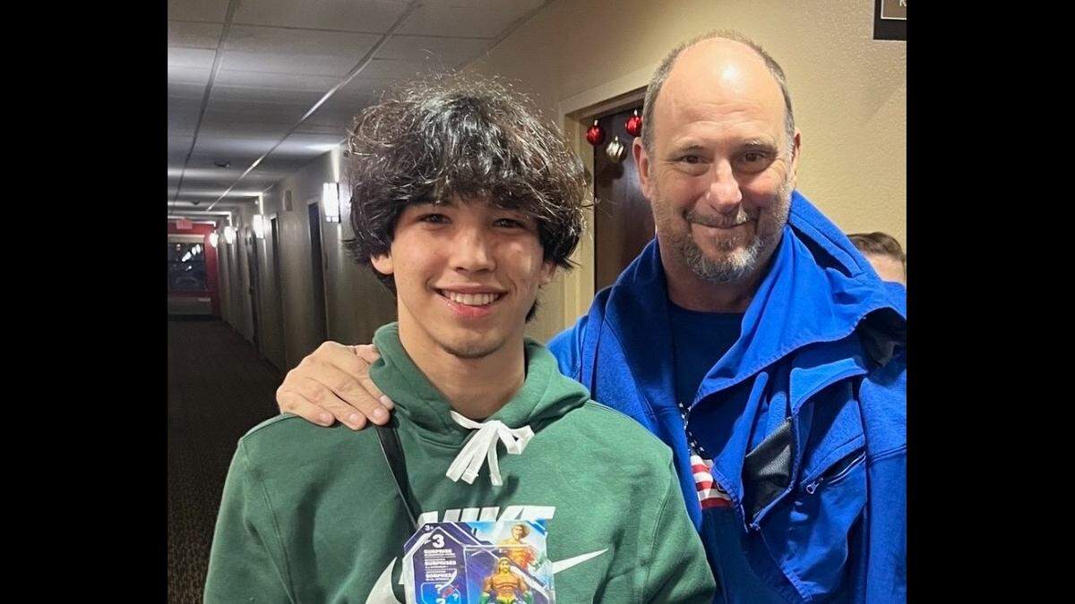 Jann Michael Feeney, who died in March 2024, and Andrew Gugliemini, his Manatee High School wrestling coach, pose for a photo at a holiday tournament in New Jersey.