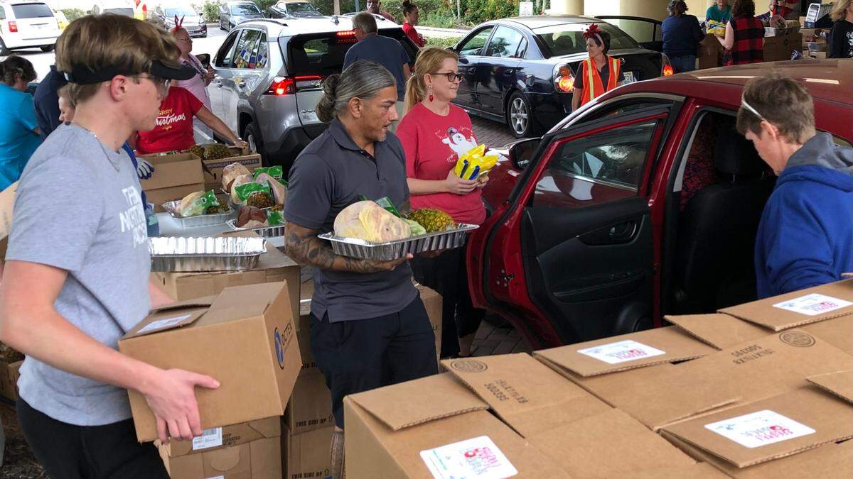 12/20/2021--Meals on Wheels PLUS of Manatee volunteers distributed hams, canned vegetables, and all the fixings to 500 Bradenton area families this week to help them prepare a traditional holiday meal at home.