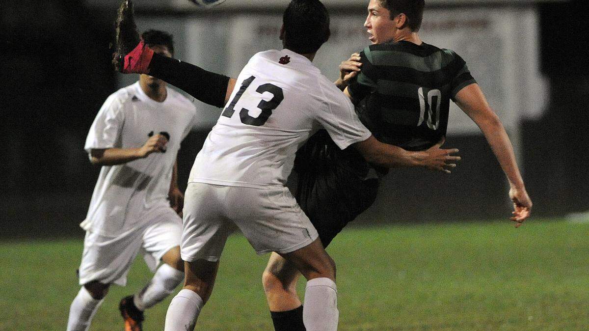Lakewood Ranch's Tyler Puhalovich and Palmetto's Gilberto Caballero vie for the ball during Friday night's foggy game. 
 TIFFANY TOMPKINS-CONDIE/Bradenton Herald