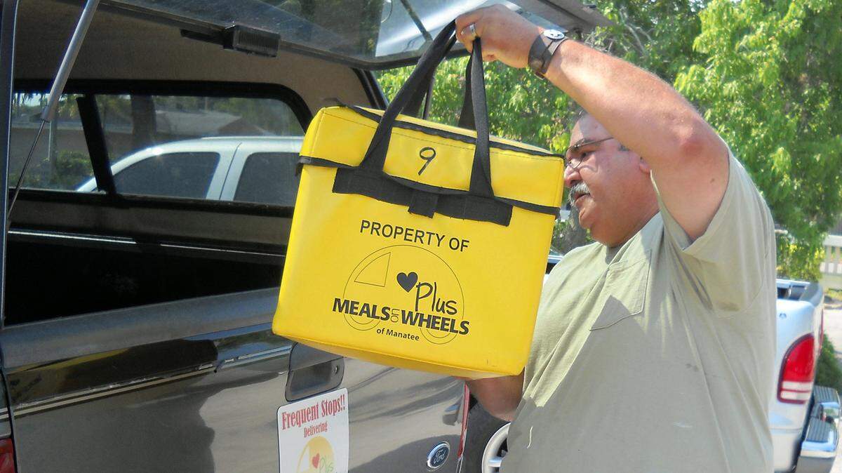 Richie Torres begins loading up for her Meals on Wheels Plus delivery. Meals on Wheels Plus is looking for volunteers right now due to a critical shortage. 
 Bradenton Herald File Photograph