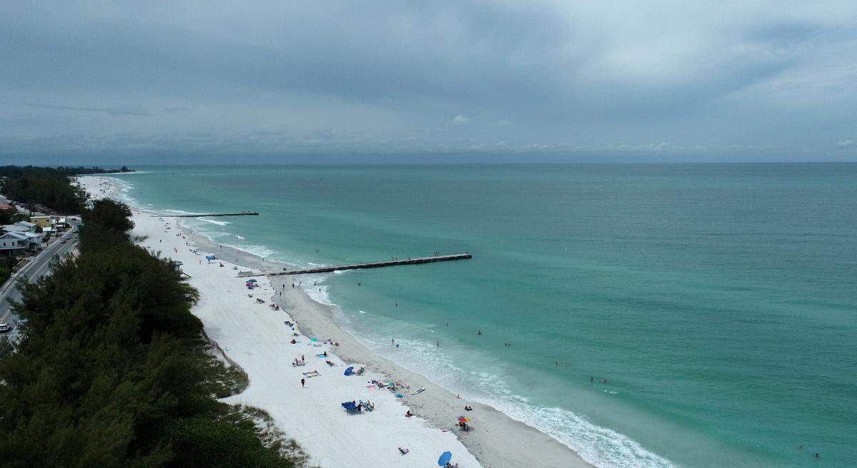 Rain bands from a tropical disturbance impacting South Florida had not made their way to Manatee County beaches mid-morning Friday. The National Hurricane Center is forecasting the system to slightly strengthen into a tropical storm.