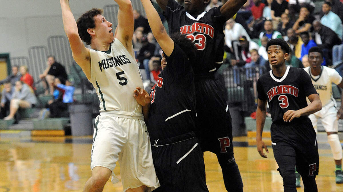 Lakewood Ranch's Sam Hester jumps for a shot as Palmetto's Kerwon Jackson and Jermain Graham try to block him in Friday night's class 7A-district 11 finals at Lakewood Ranch. 
 TIFFANY TOMPKINS/Bradenton Herald