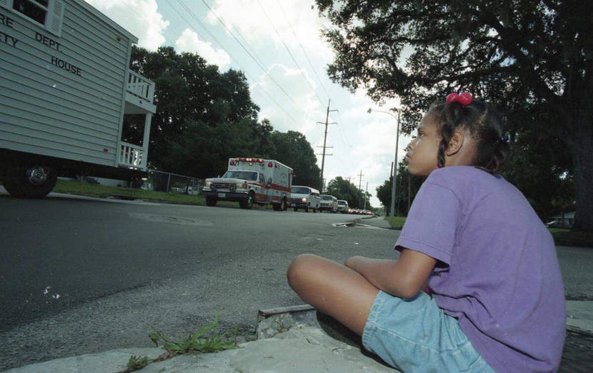 A young girl watched the inaugural Bradenton Juneteenth Celebration Parade in 1996