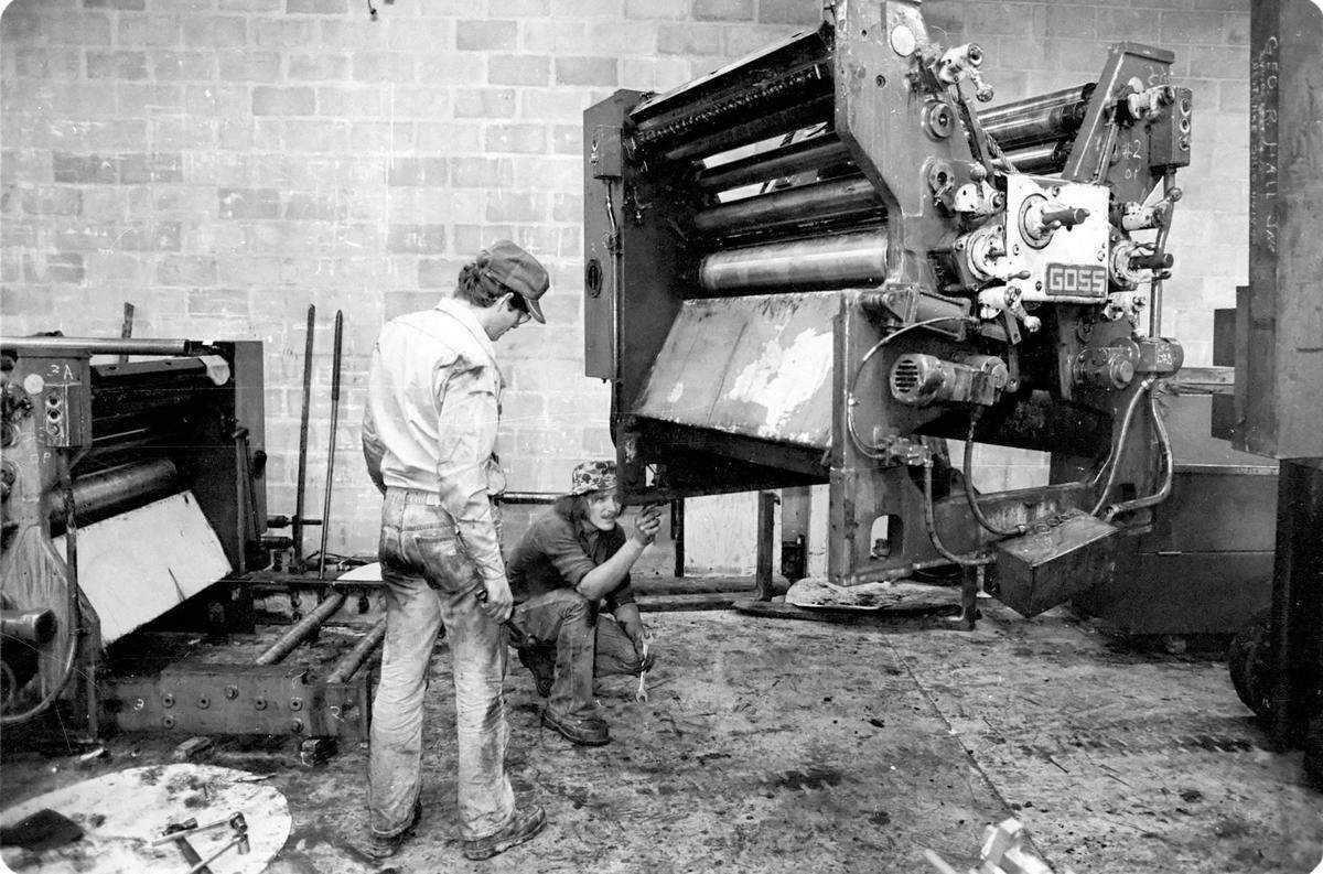 Bradenton Herald employees check the type and layout of a page before publication, 1979.