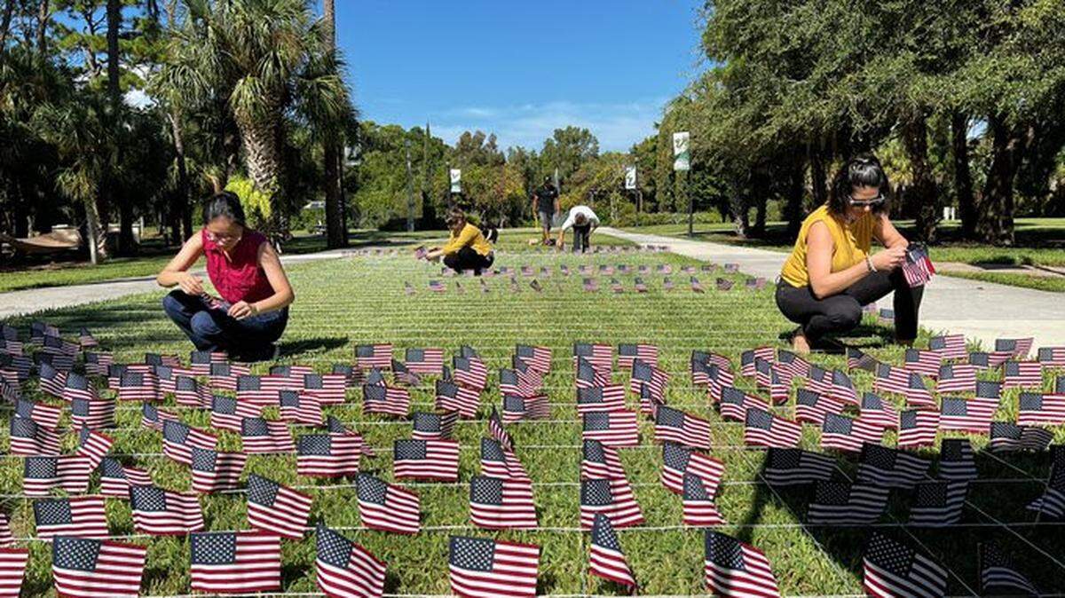 Volunteers on Tuesday planted 2,977 small American flags on the USF Sarasota-Manatee campus courtyard, one for each of the people who died in the attacks.