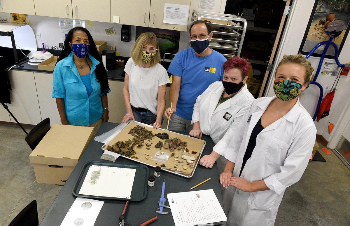 From left, Dr. Rosalyn Howard, Sherry Svekis, Dr. Uzi Baram, Jean Lammie and Mary Maisel examine artifacts unearthed from Manatee Springs in a quest to shed light on Angolan settlers are examined at the Public Archaeology Lab at New College.