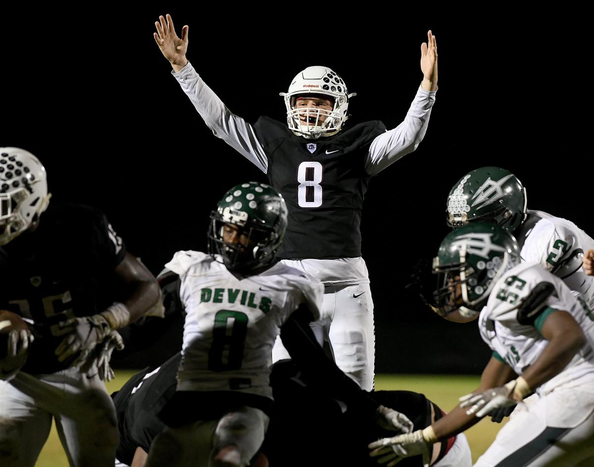 Bryan Gagg celebrates a touchdown by Knowledge McDaniel during Friday night’s game at Pirate Stadium between Braden River and St. Petersburg High.
