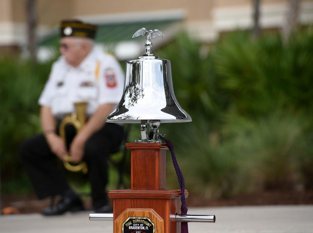 Joe Best of the VFW Post 10141 sits in the background at the Tribute to Heroes Memorial Service at Bradenton’s Riverwalk Tuesday morning.