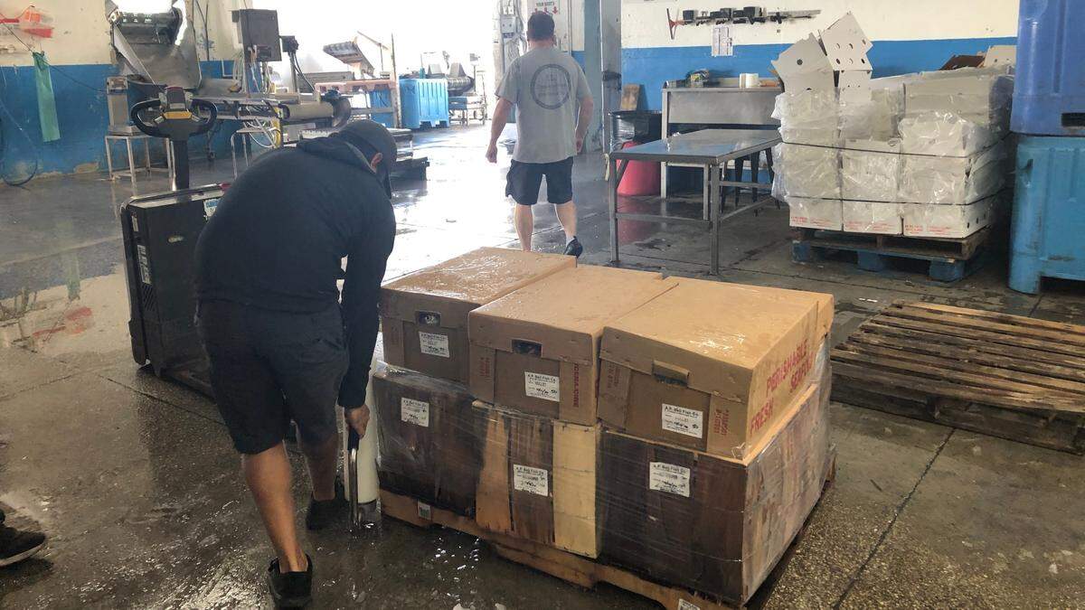 A worker wraps a pallet of seafood at A.P. Bell Seafood, 4600 124th S. W., Cortez.