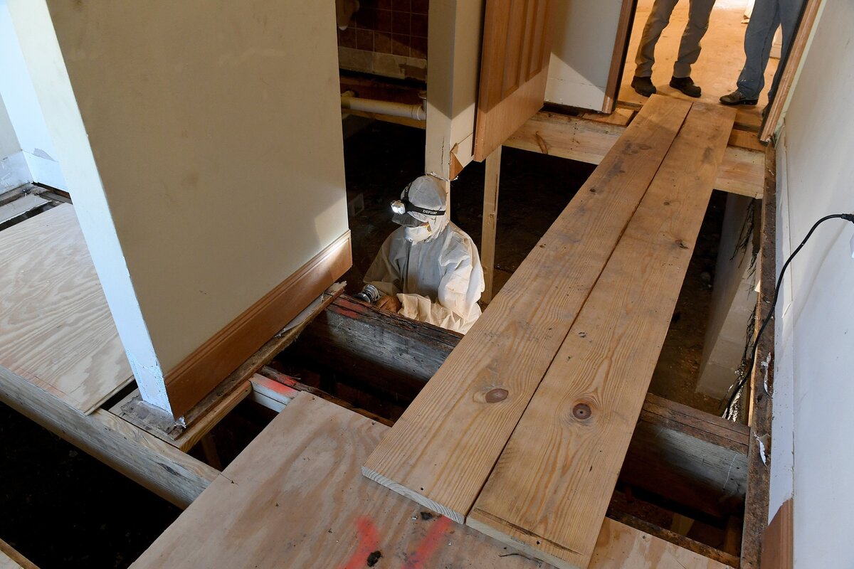 The former Comfort Cove is now under new ownership and being redeveloped as Villas of Holly Brook by a new developer, Reggie Phillips, who is a part time Anna Maria Island resident. A worker in protective gear works on the sub-floor of the first floor.