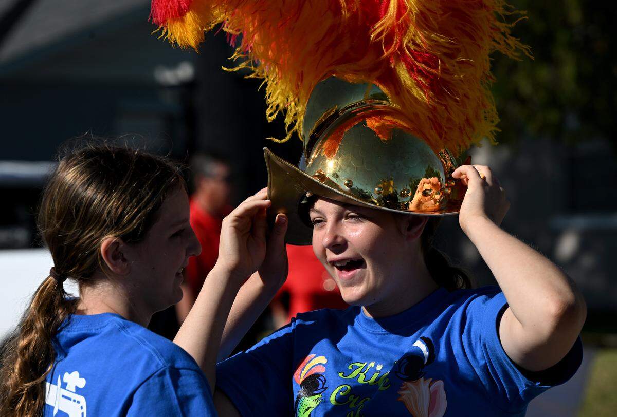 Kaylee Varnadore tries on a conquistador helmet at the Children’s Parade.