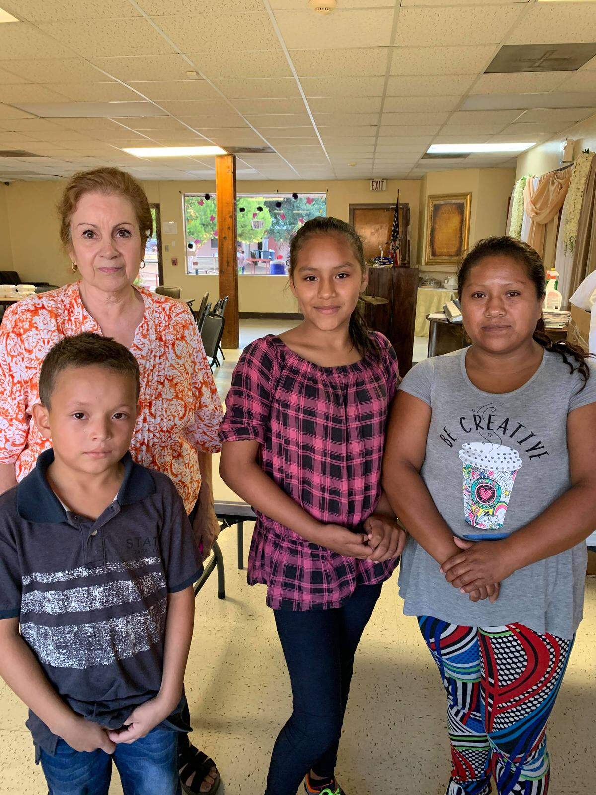 Teacher and artist Caridad Sarabia Ramos Cisneros, top left, met with families from Guatemala at a shelter in Texas last July to give the children activity books and toys. She also taught them important words and “survival phrases” in English.