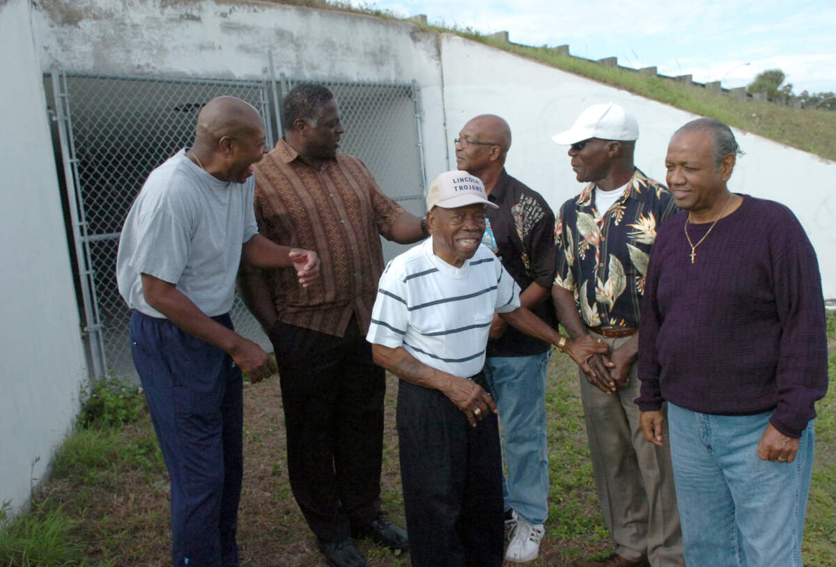 Some of the members of the Lincoln Trojans shared memories as they gathered by the tunnel featured in “Through the Tunnel” in Lincoln Park in Palmetto in 2009; Henry Jones, Henry Lawrence, Chip Nelson, coach Eddie Shannon, Willie Jones and Robert N. Hamilton.