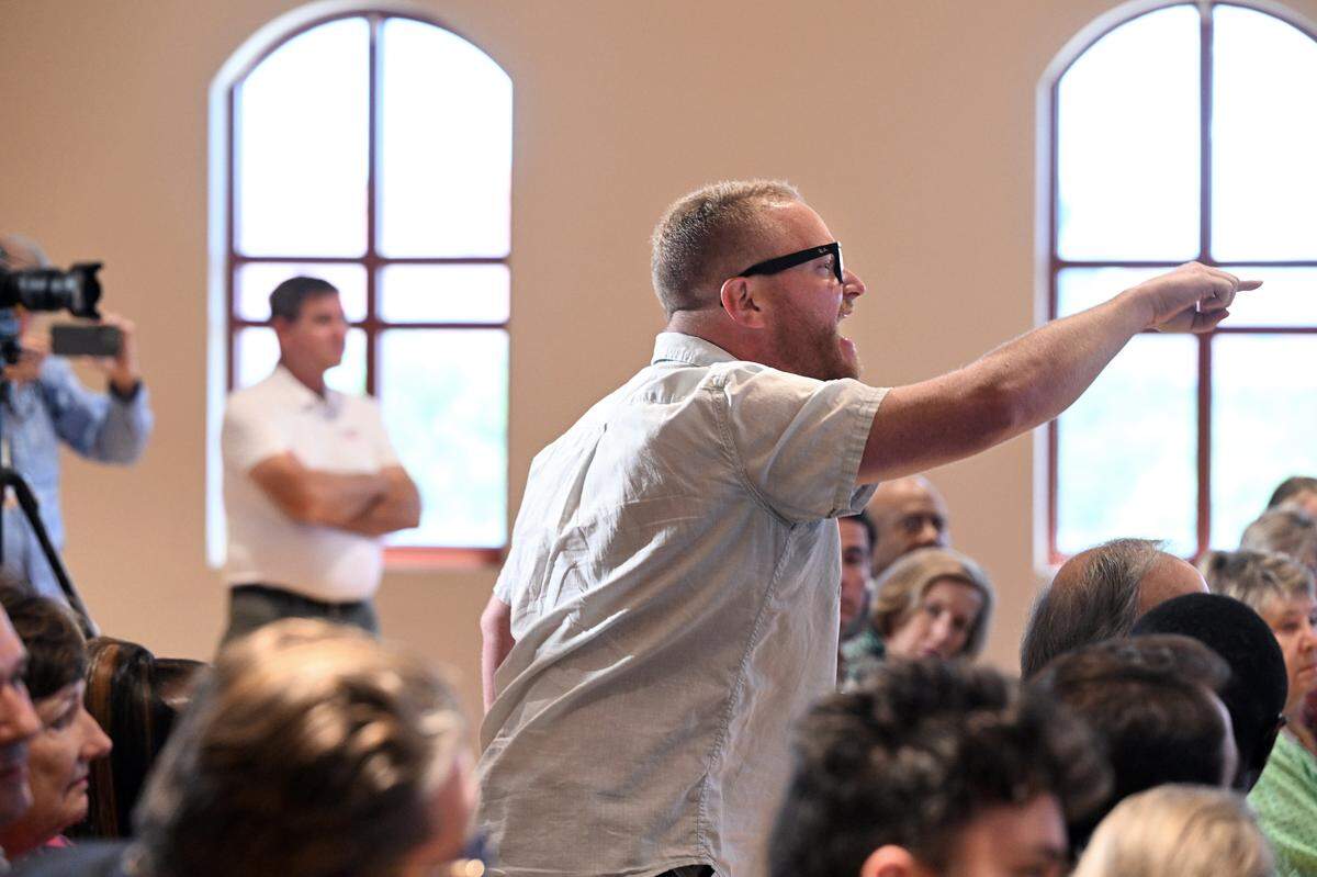 A protester distrupted a press conference while Florida Governor Ron DeSantis spoke at the Manatee Performing Arts Center in Bradenton on July 24, 2025.