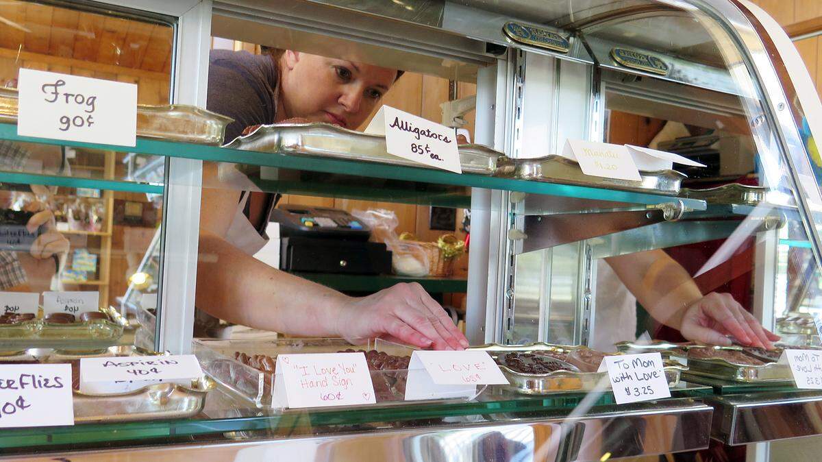 Mardee Westerman, owner of Richey's Fine Chocolates in Bradenton, gets the display cases of her shop at 4710 Manatee Ave. W. ready for an expected Friday and Saturday rush of Mother's Day business. MATT M. JOHNSON/Bradenton Herald