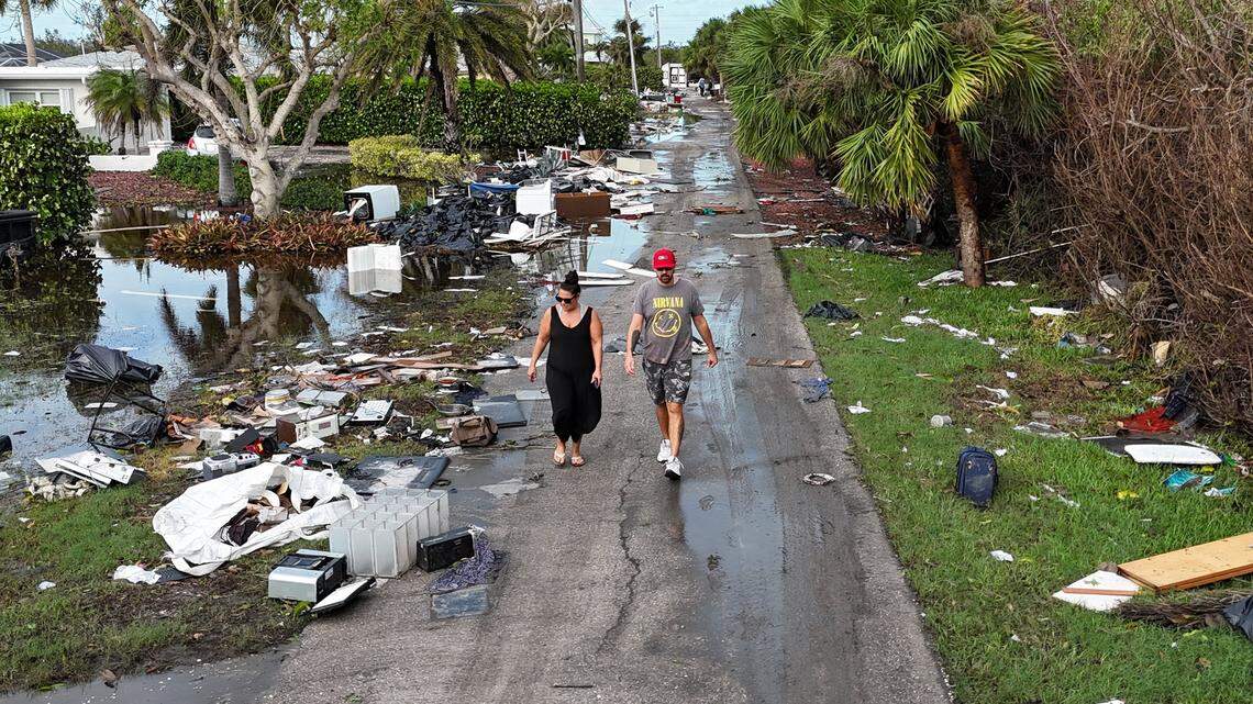 Locales Brian Rhodes and Trish Cloutier surveying damage and debris in front of homes in Charlotte County near Manasota Key on Thursday, Oct. 10, 2024, the morning after Hurricane Milton hit the area.