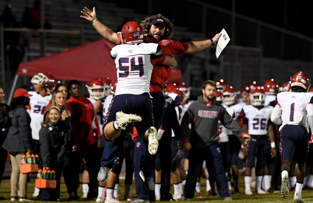 Manatee’s Sam Purcell and coach Thor Miller celebrate a touchdown during Friday night’s Class A Region 2 semifinals between Manatee and Riverview at Riverview.