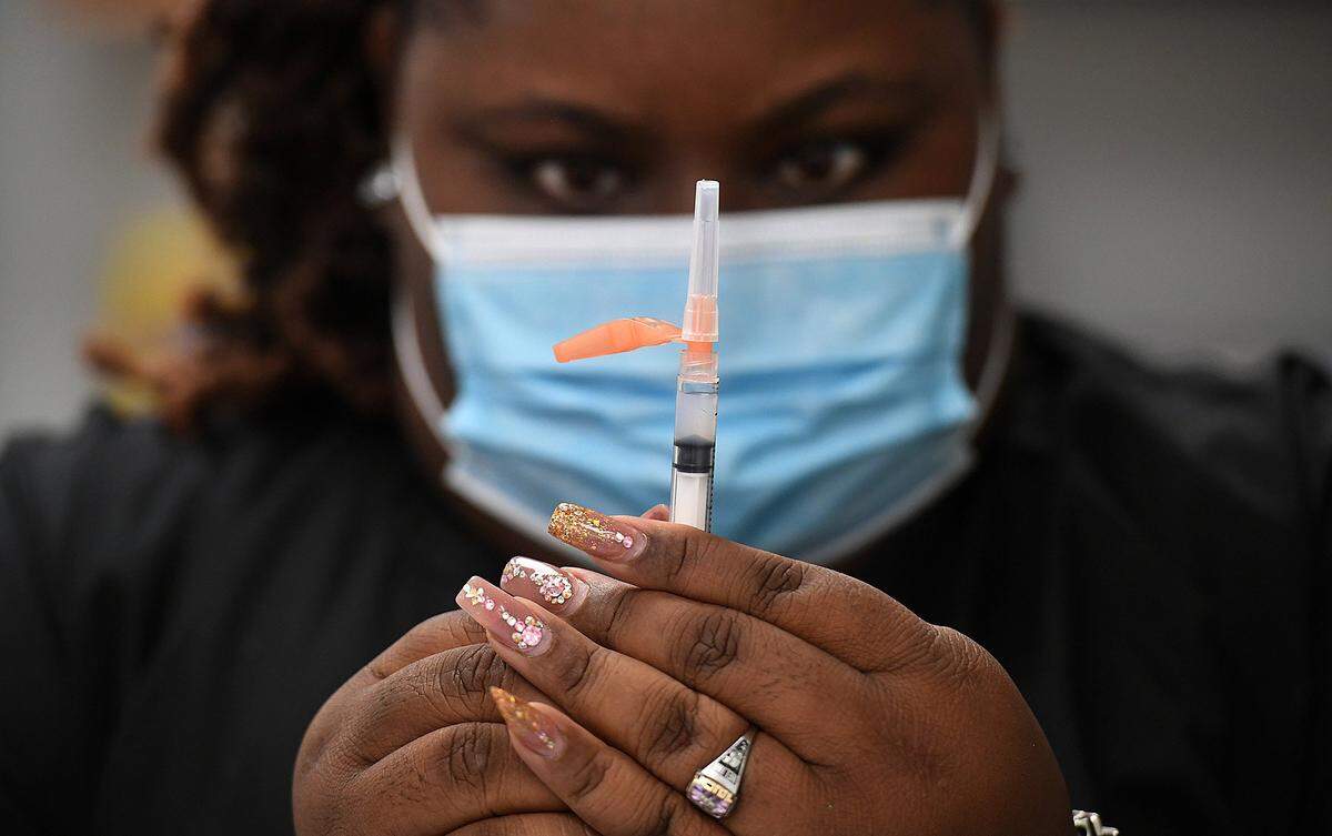 02/10/21--Empath Health has announced a policy that requires colleagues, volunteers and vendors to be fully vaccinated against COVID-19. Shown above, MCR Health employee Helina Lovell fills syringes during a COVID-19 vaccination event in February for residents at the Rubonia Community Center.