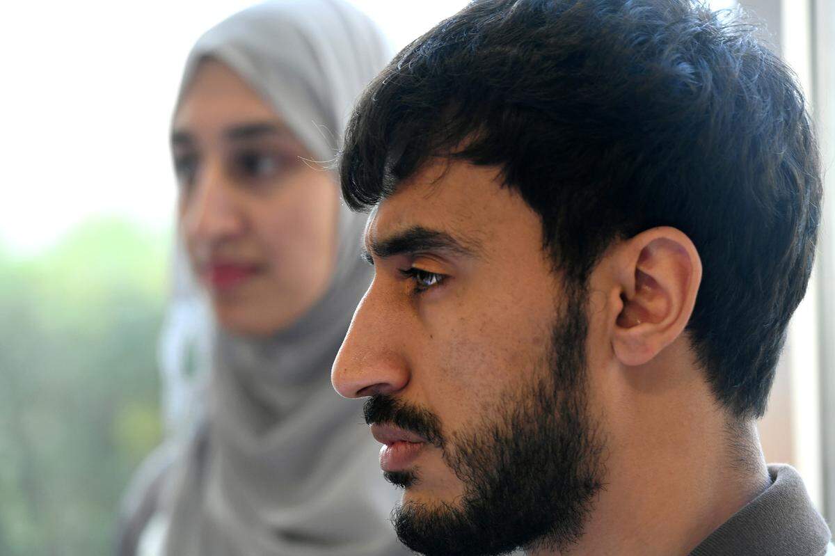 Noman Raoufi and his sister, Venus, at Westminster where they both now work after immigrating from Afghanistan.