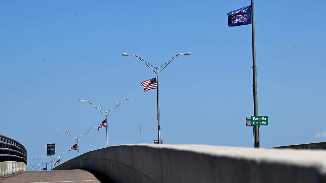 American flags fly from the light posts along the Green Bridge spanning from Bradenton to Palmetto shown on April 24, 2026. On the center pole flies a flag commemorating America’s 250th anniversary.