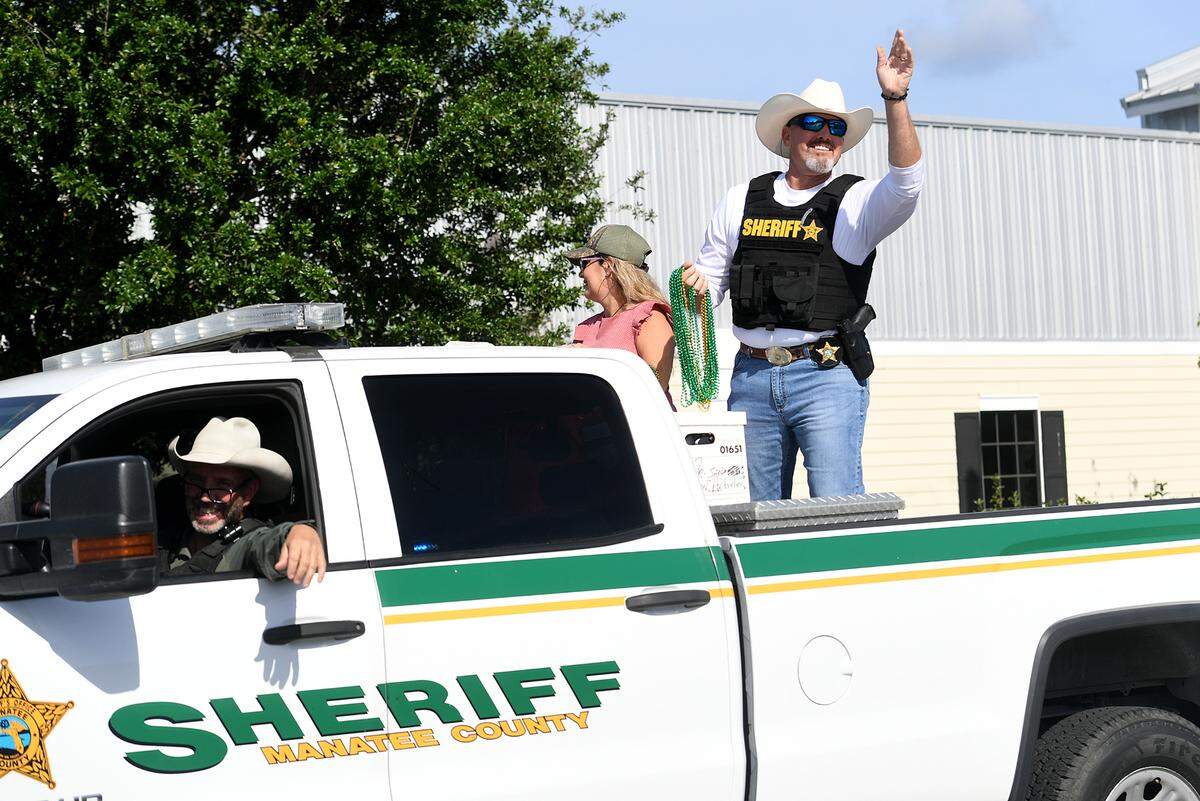 Sheriff Rick Wells waves and throws beads in the Hernando DeSoto Historical Society’s Children’s Parade on Friday, April 7, 2023 in Palmetto.